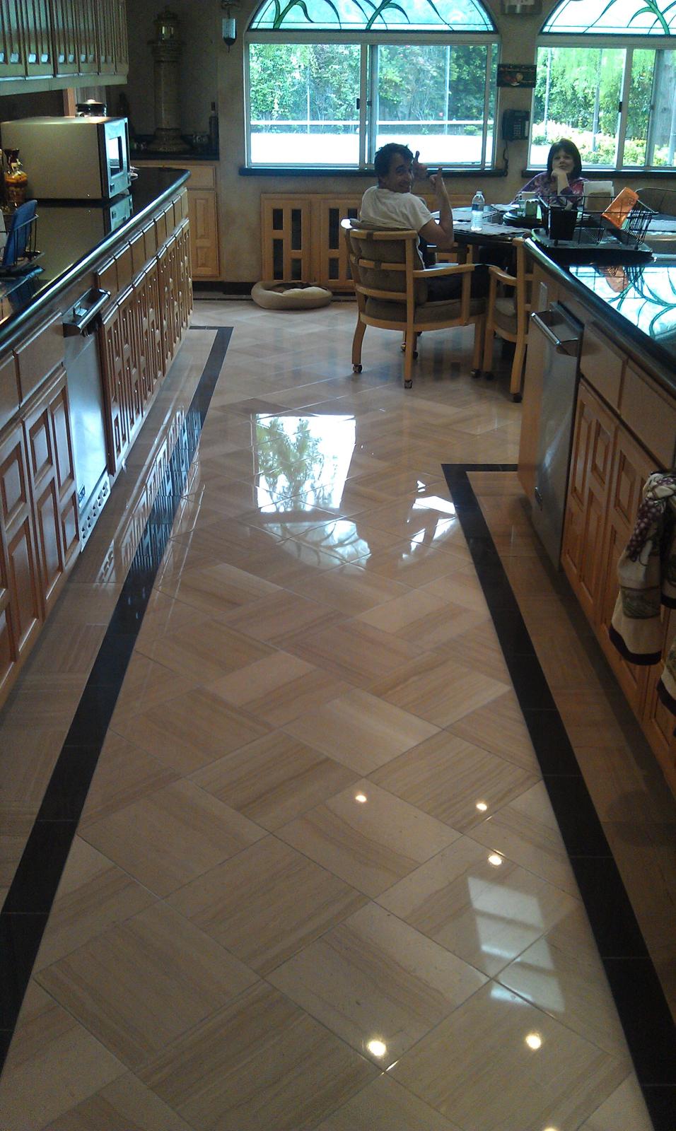 Marble entryway floor before grinding, showing deep scratches and uneven wear