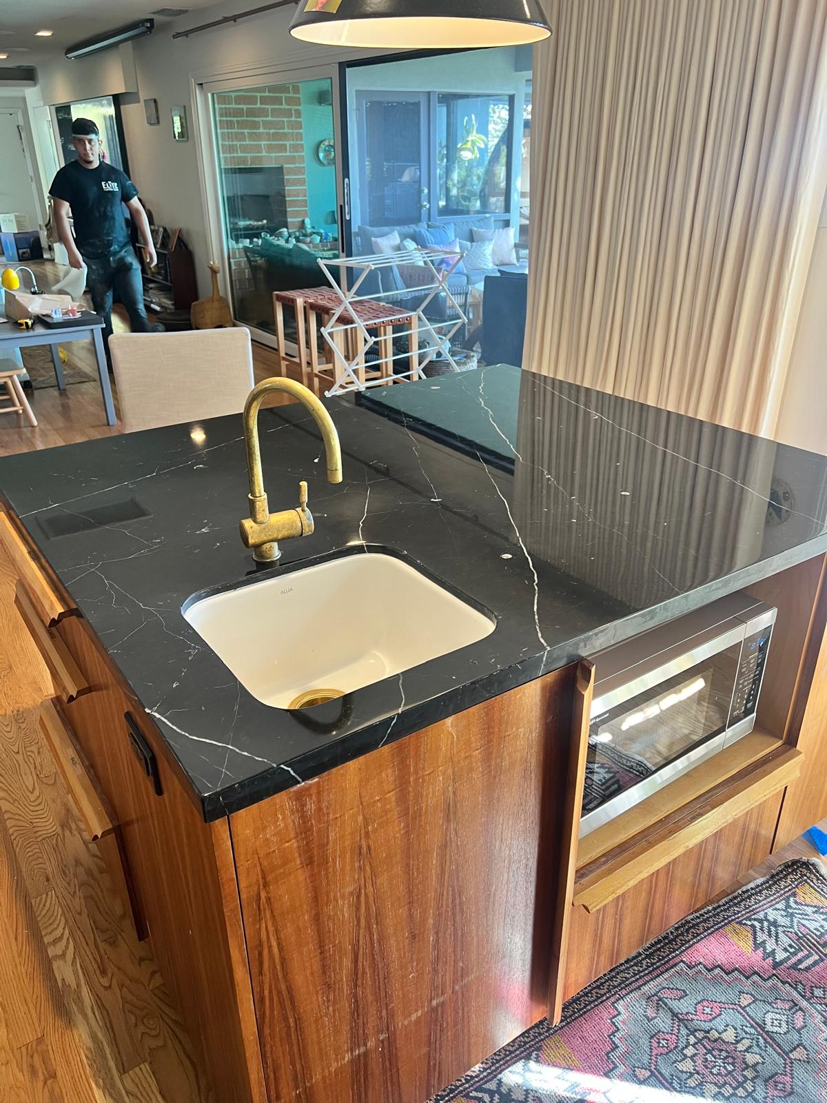 Marble floor before stripping, showing yellowed, cracked wax coating