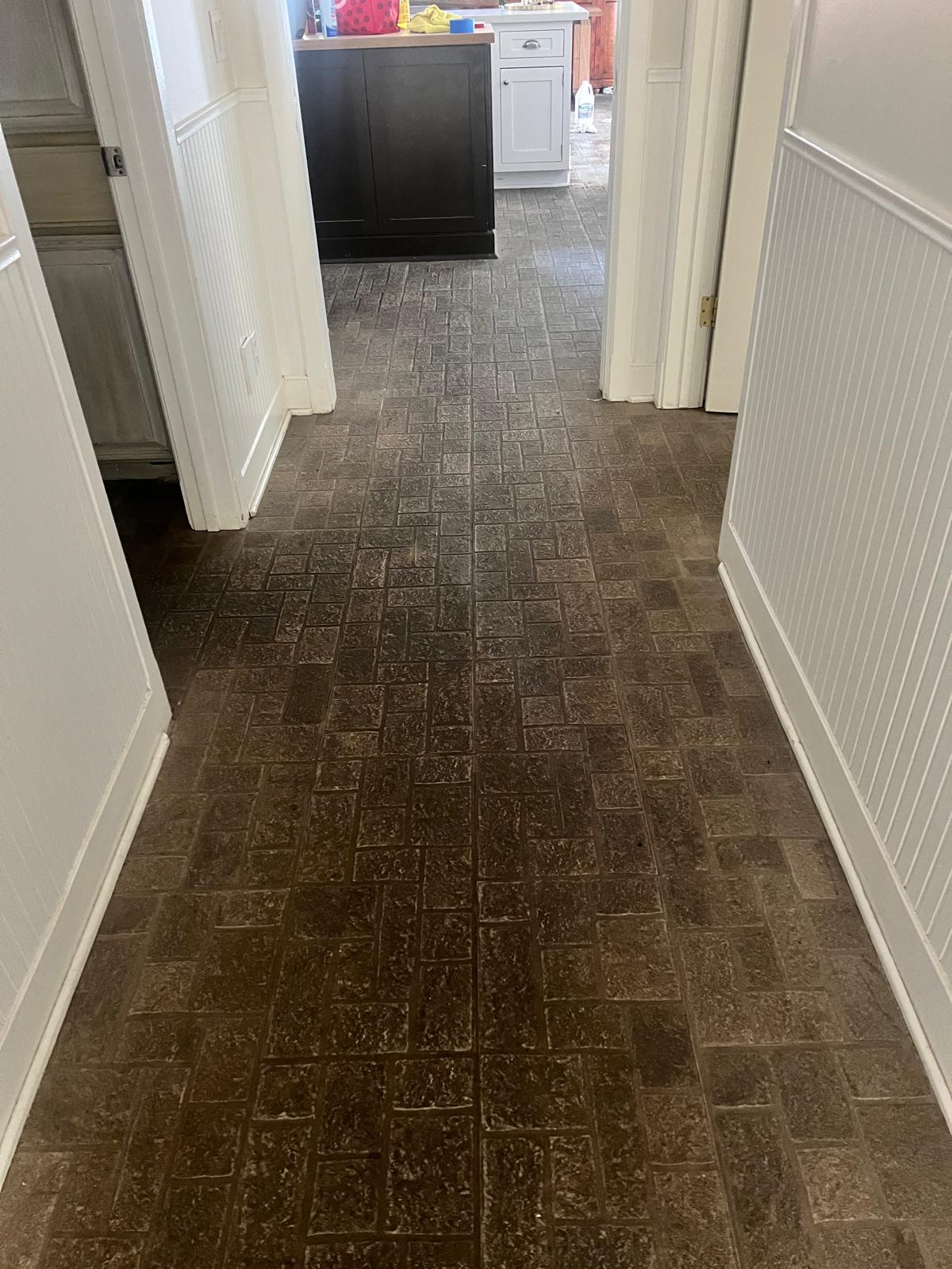 Hallway floor showing the contrast between old coating and a stripped surface