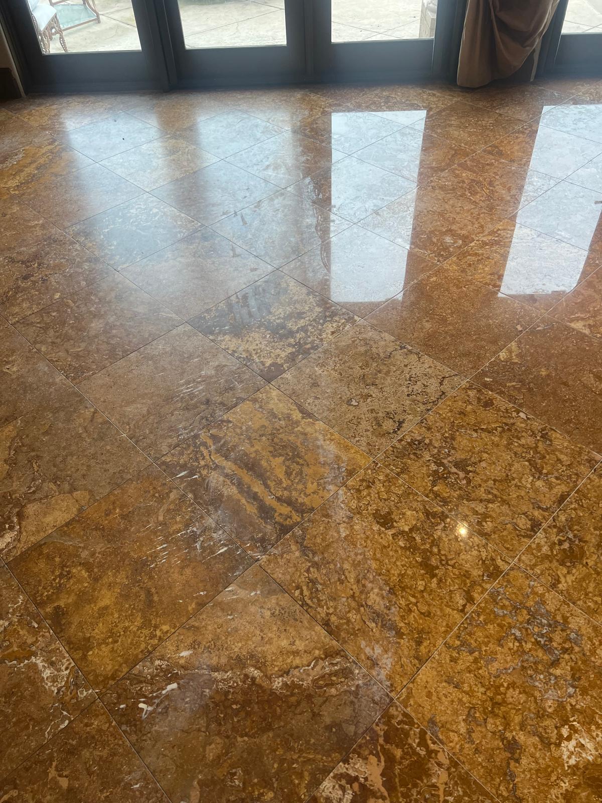 Polished travertine floor with a bright reflective finish