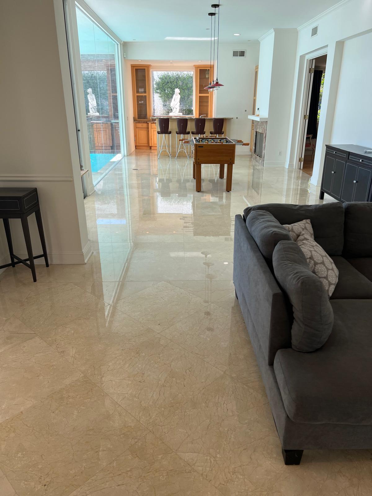 Restored beige marble floor with a bright reflective finish