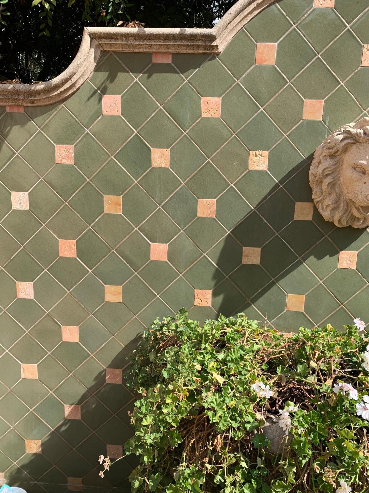 Clean outdoor tiled wall after professional stone cleaning
