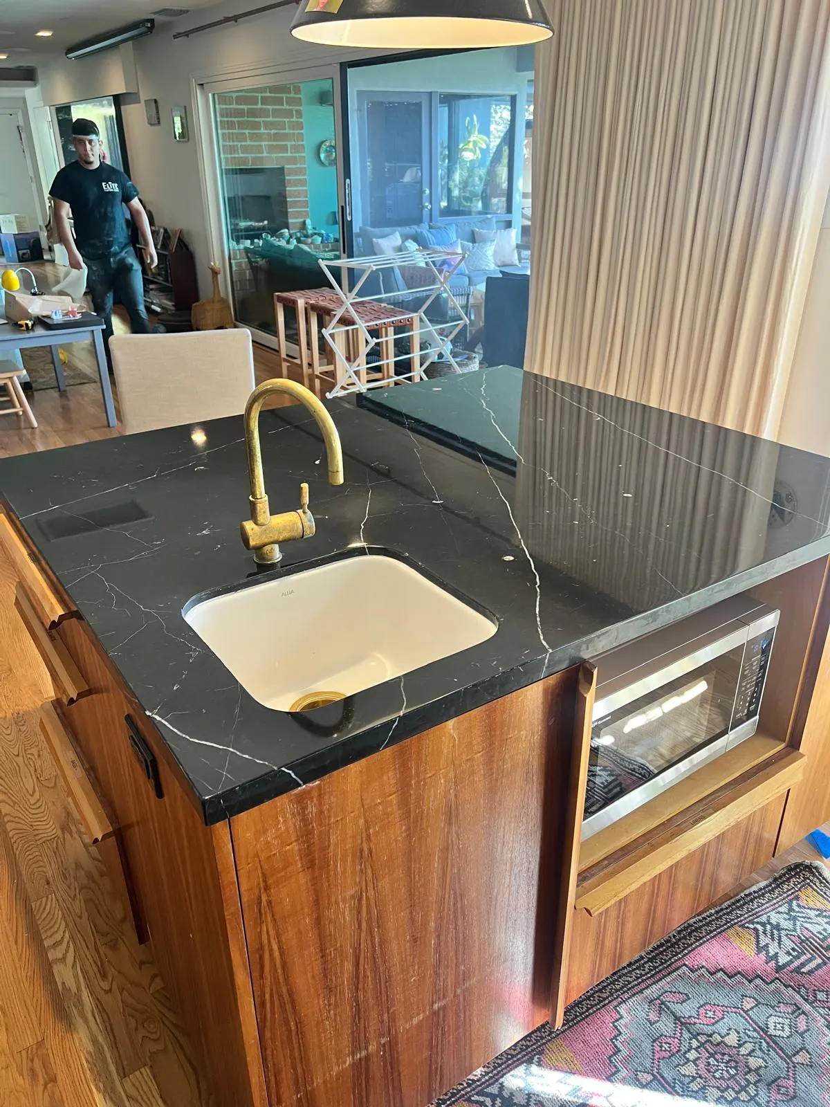 Marble floor before stripping, showing yellowed, cracked wax coating