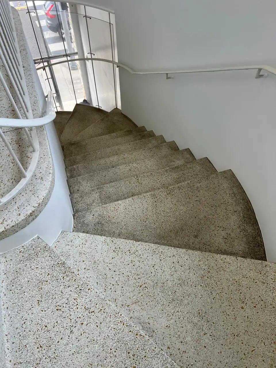 Dull terrazzo staircase before honing and finish restoration