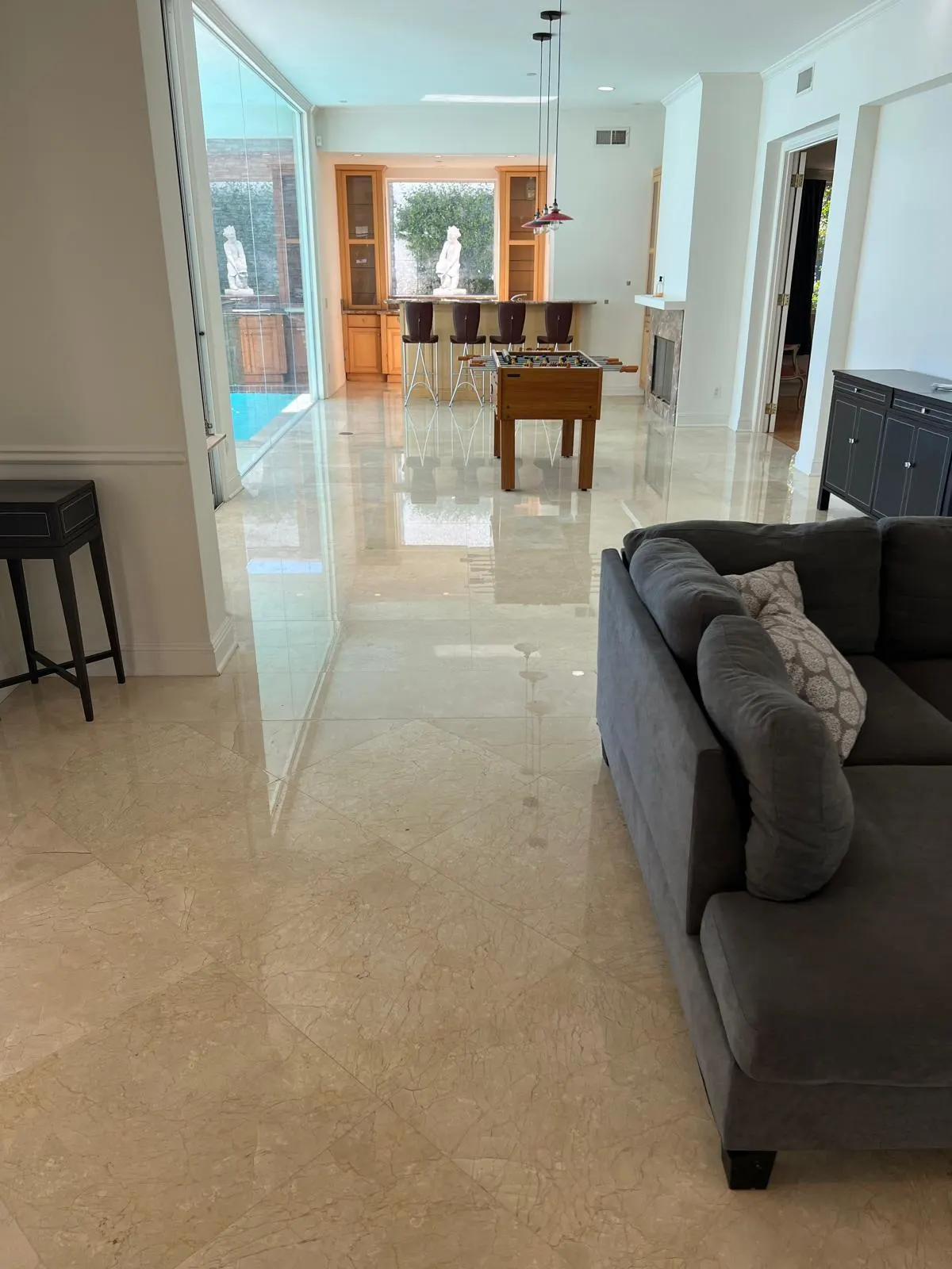 Restored beige marble floor with a bright reflective finish